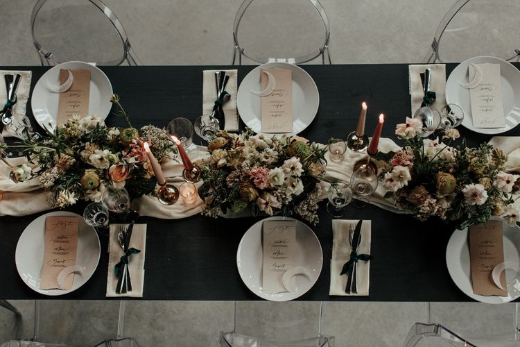 Intimate reception tablescape with flower and candle centrepiece decor