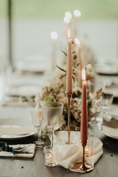 Pink taper candles in gold candlesticks