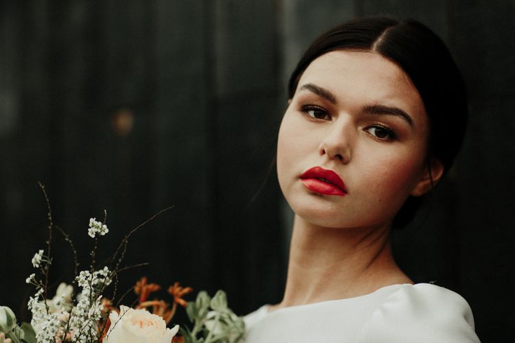 Bride in sleek bun with red lipstick