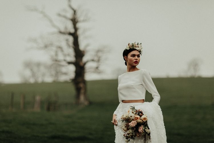 Boho bride in flower crown and bridal crop top with long sleeves