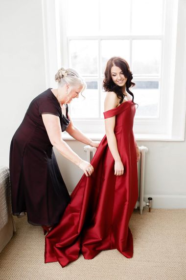 Wedding Morning Bridal Preparations | Bride in Bespoke Red Dress from Agape Bridal Boutique | Red New Years Eve Winter Wedding at Iscoyd Park, Shropshire | White Stag Wedding Photography | Lovetwofilm