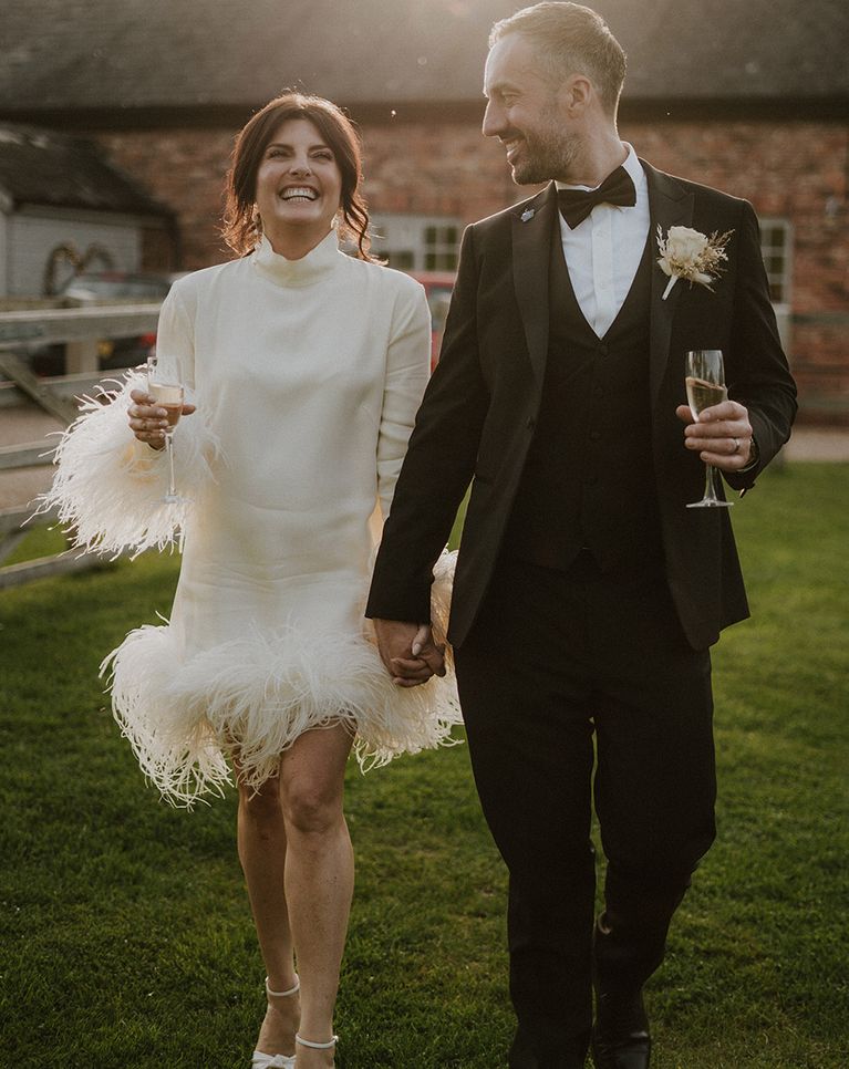 Bride wearing short winter wedding dress with feathers