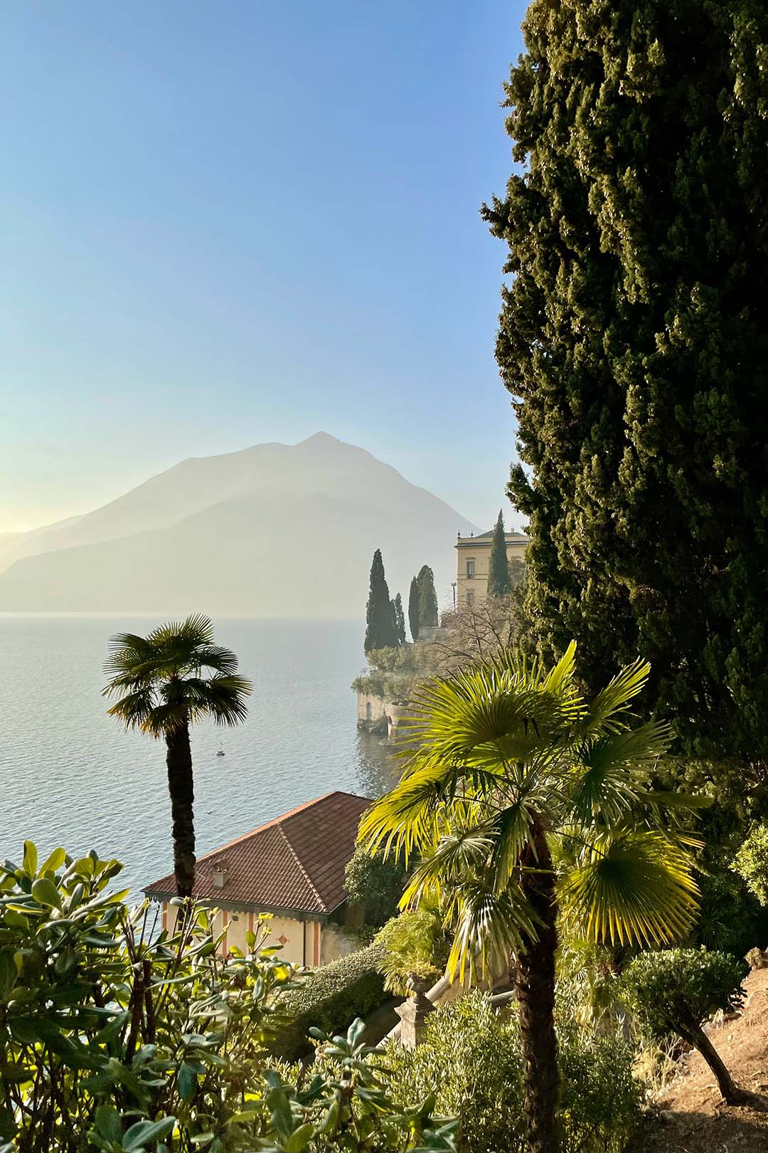 Image of hillside Italian villas with view of the sea and mountains 