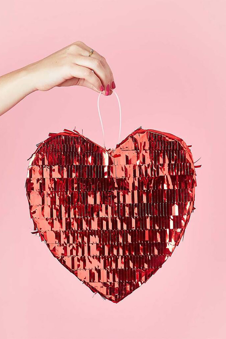 Red heart shaped pinata with foil tassels from Not On The High Street