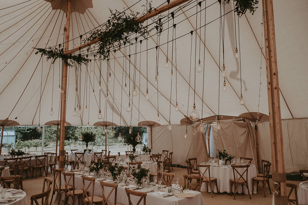 Marquee Wedding at Home on The Isle of Wight with Foliage and Edison
