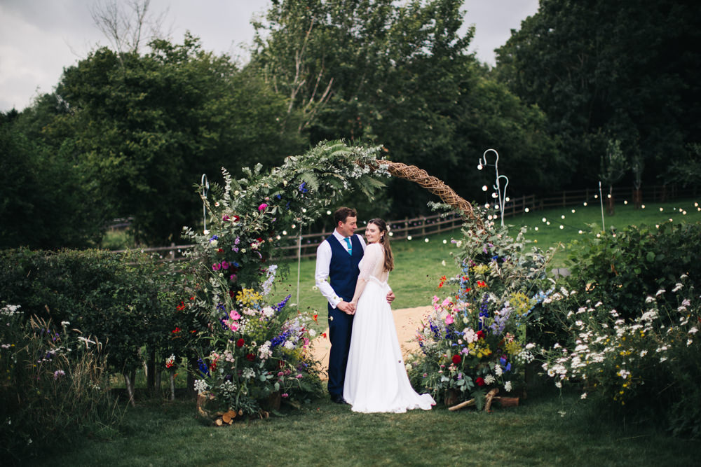 Moon Gate Arch With Bright Flowers For Garden Marquee Wedding